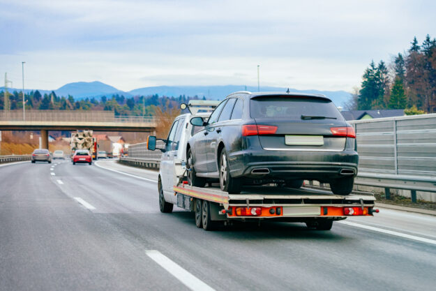 Tow truck with car on warranty in road Tow Truck With Car On Warranty In Road