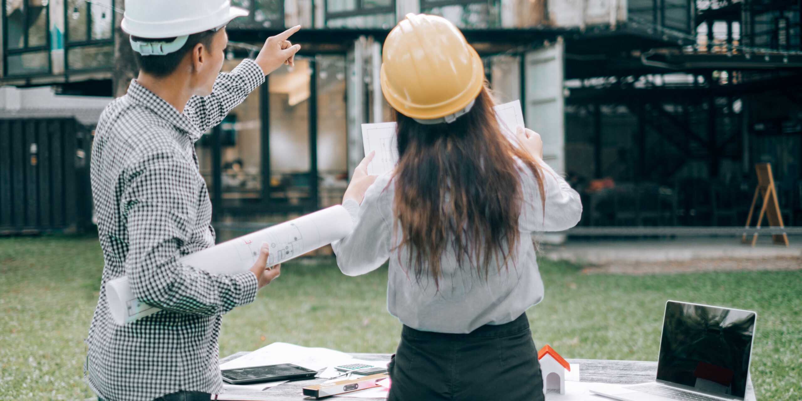 Rear View Man With Woman Standing Against Built Structure
