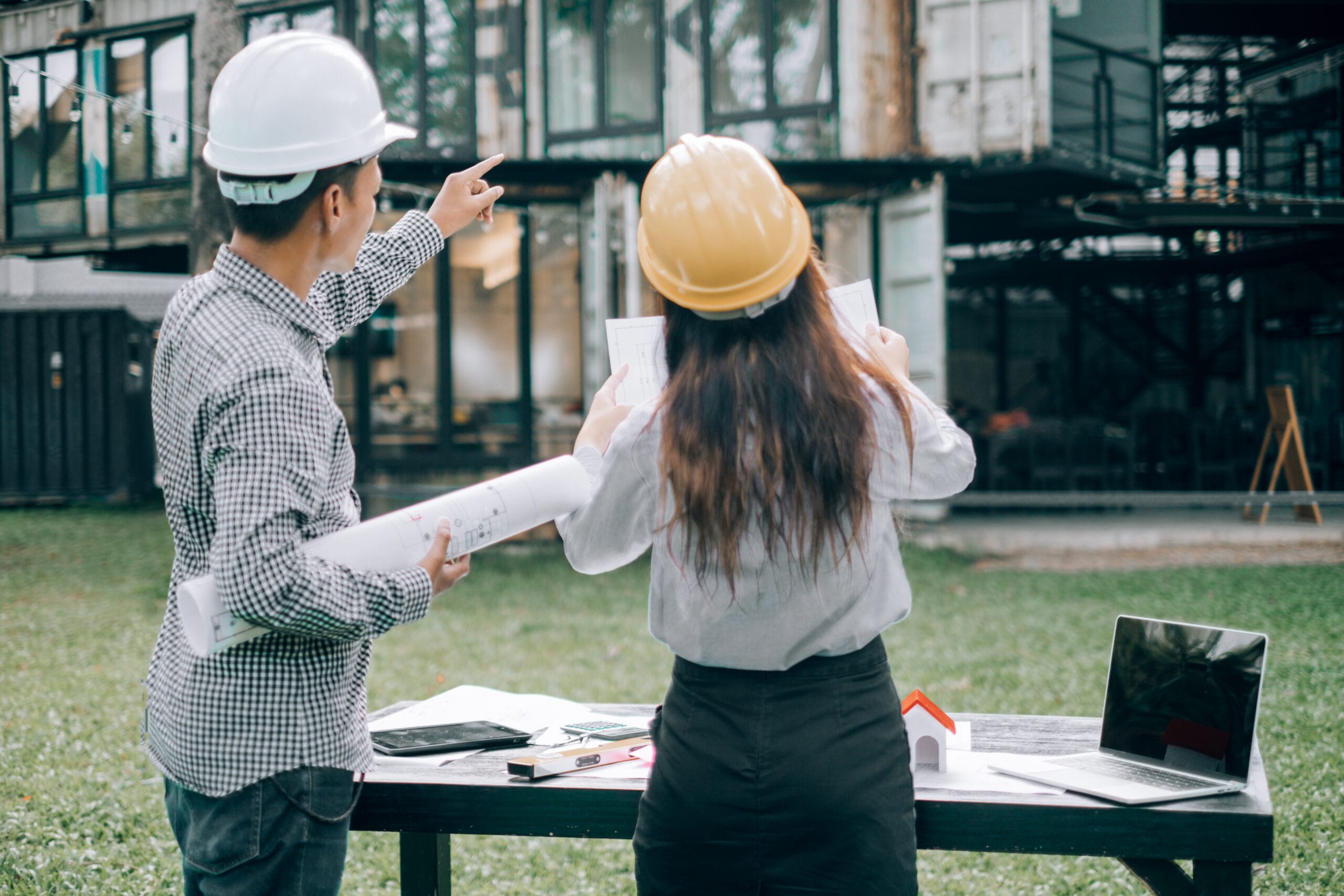 Rear View Man With Woman Standing Against Built Structure
